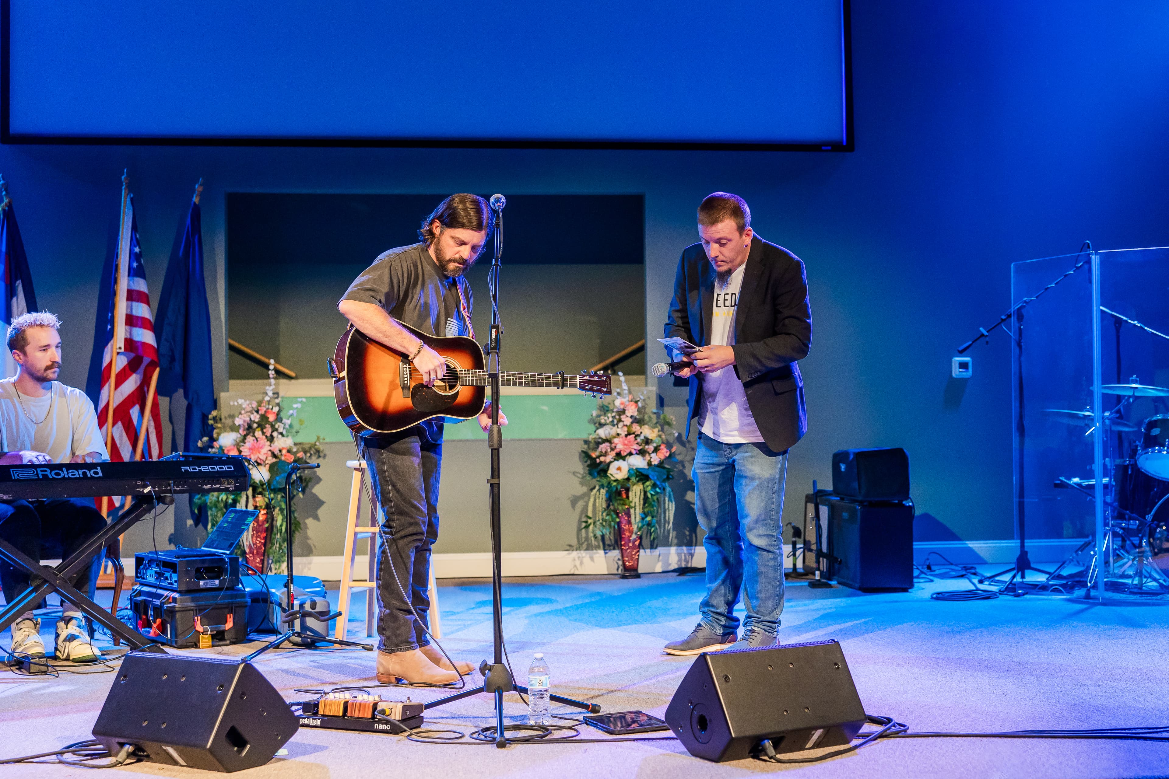 Justin and Josh Baldwin on stage at formal event