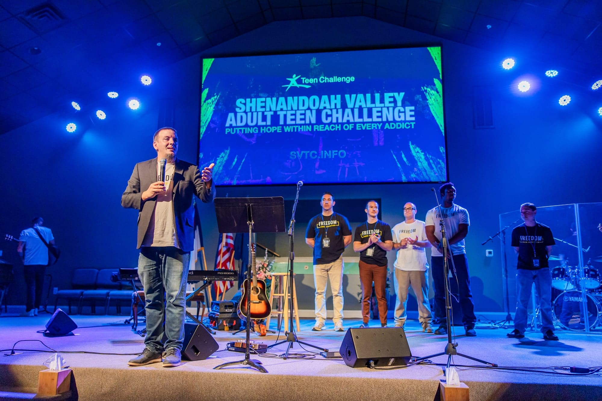Teen Challenge students gathered on stage during a worship service